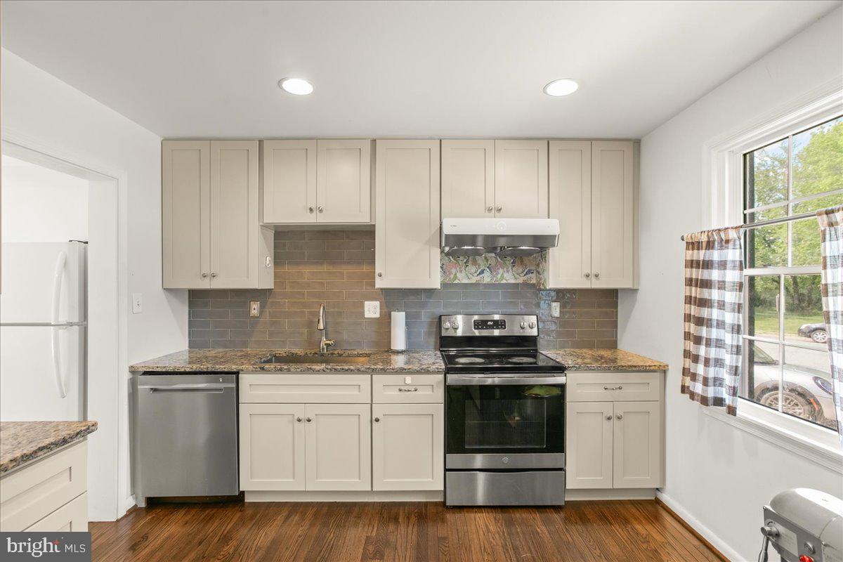 7213 Evanston Road Springfield, VA 22150 - Photo 12 of 37 Modern kitchen with sleek finishes.