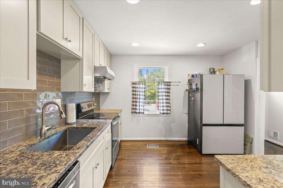 7213 Evanston Road Springfield, VA 22150 - Photo 15 of 37 Modern kitchen with stylish finishes.