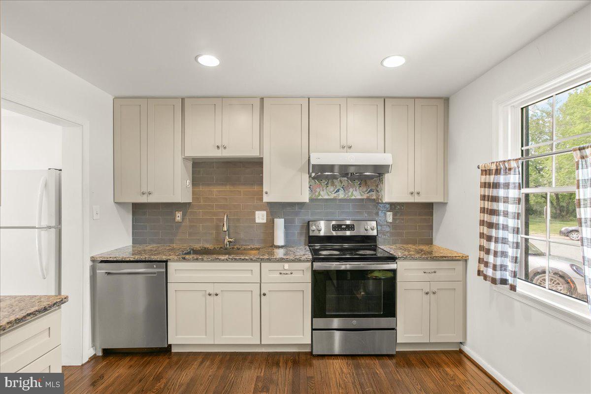 7213 Evanston Road Springfield, VA 22150 - Photo 16 of 37 Modern kitchen with sleek finishes.