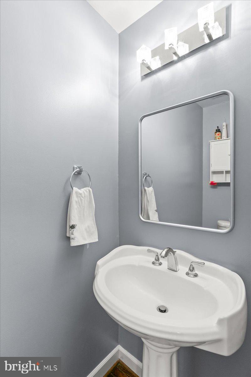 7213 Evanston Road Springfield, VA 22150 - Photo 18 of 37 Sleek powder room with modern accents.