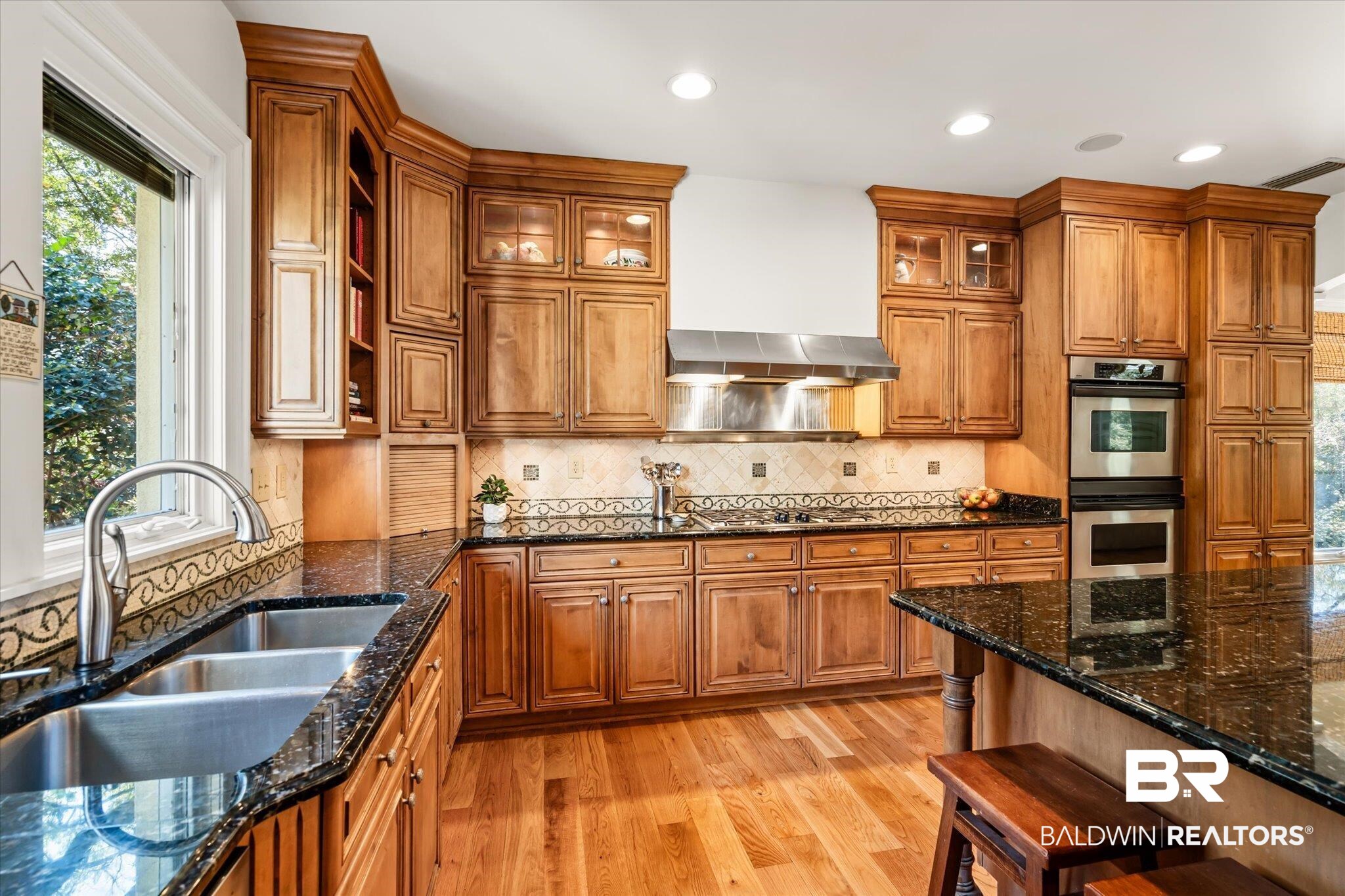 4 Kingsway Mobile, AL 36608 - Photo 9 of 44 Kitchen featuring light wood-style floors, brown cabinets, appliances with stainless steel finishes, and a sink