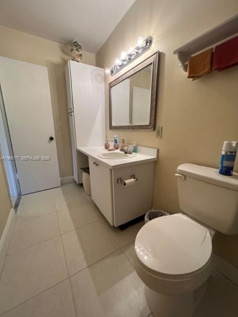 13783 Southwest 66th Street, Unit 215A Miami, FL 33183 - Photo 11 of 13 a bathroom with a toilet sink and mirror