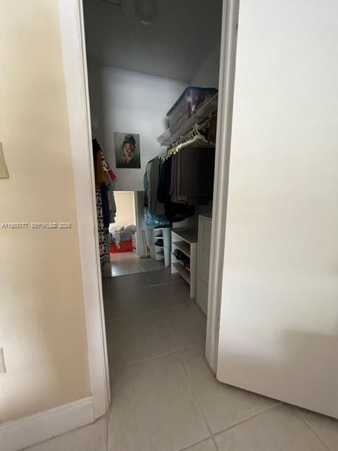 13783 Southwest 66th Street, Unit 215A Miami, FL 33183 - Photo 12 of 13 a view of walk in closet with clothes and shoes