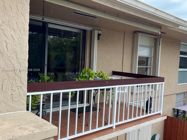 13783 Southwest 66th Street, Unit 215A Miami, FL 33183 - Photo 13 of 13 a view of a house with porch and wooden floor
