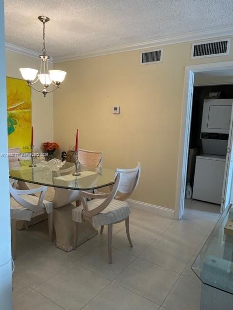 13783 Southwest 66th Street, Unit 215A Miami, FL 33183 - Photo 7 of 13 a dining room with furniture and chandelier