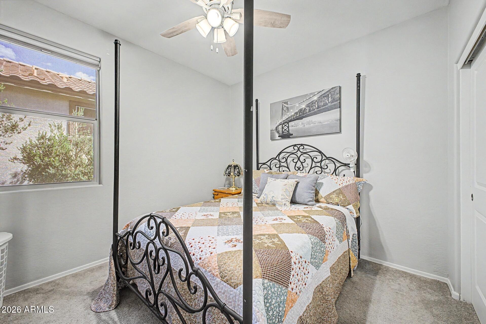 18021 West Indigo Brush Road Goodyear, AZ 85338 - Photo 20 of 47 a bedroom with a bed and wooden floor