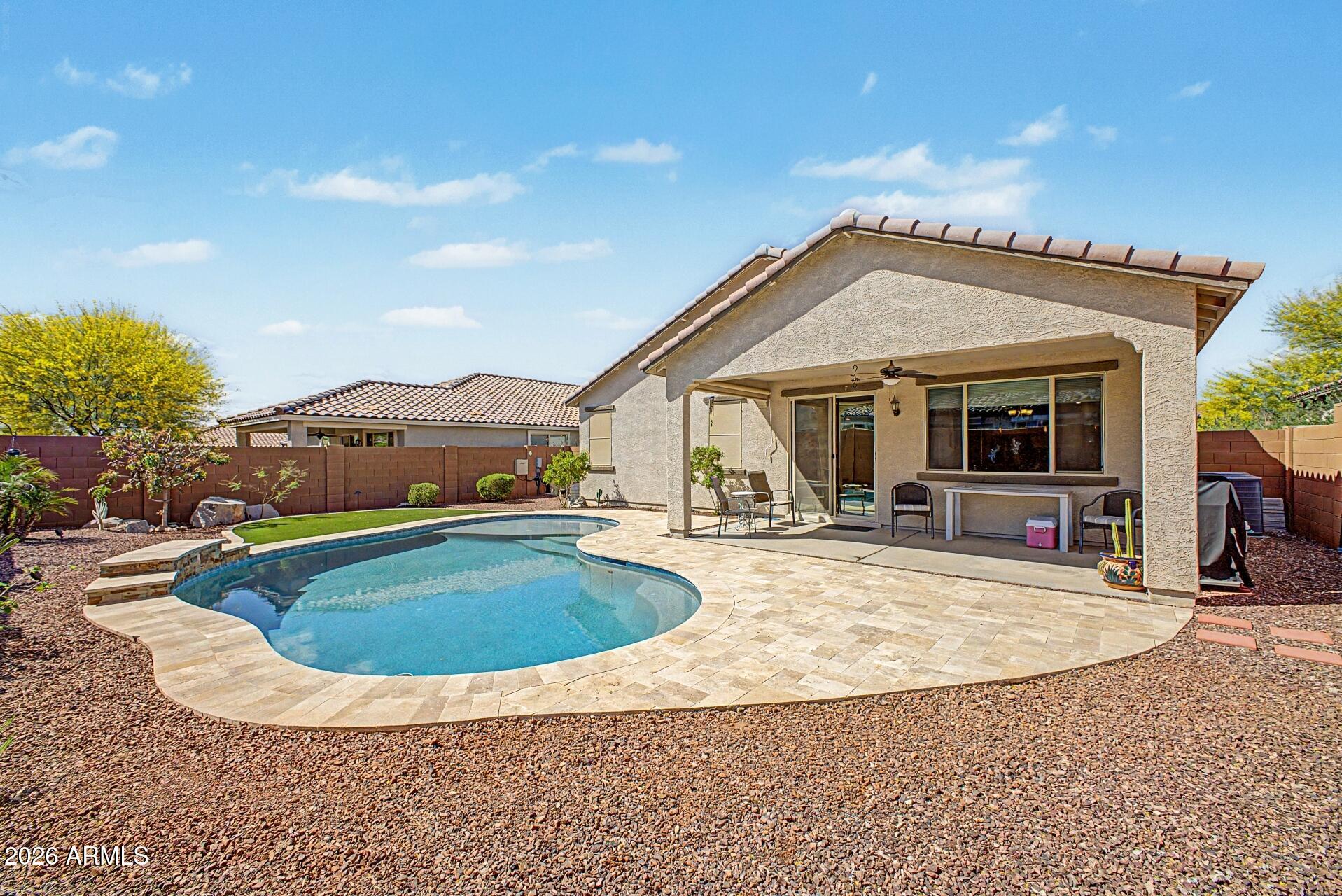 18021 West Indigo Brush Road Goodyear, AZ 85338 - Photo 2 of 47 a view of a house with swimming pool and sitting area