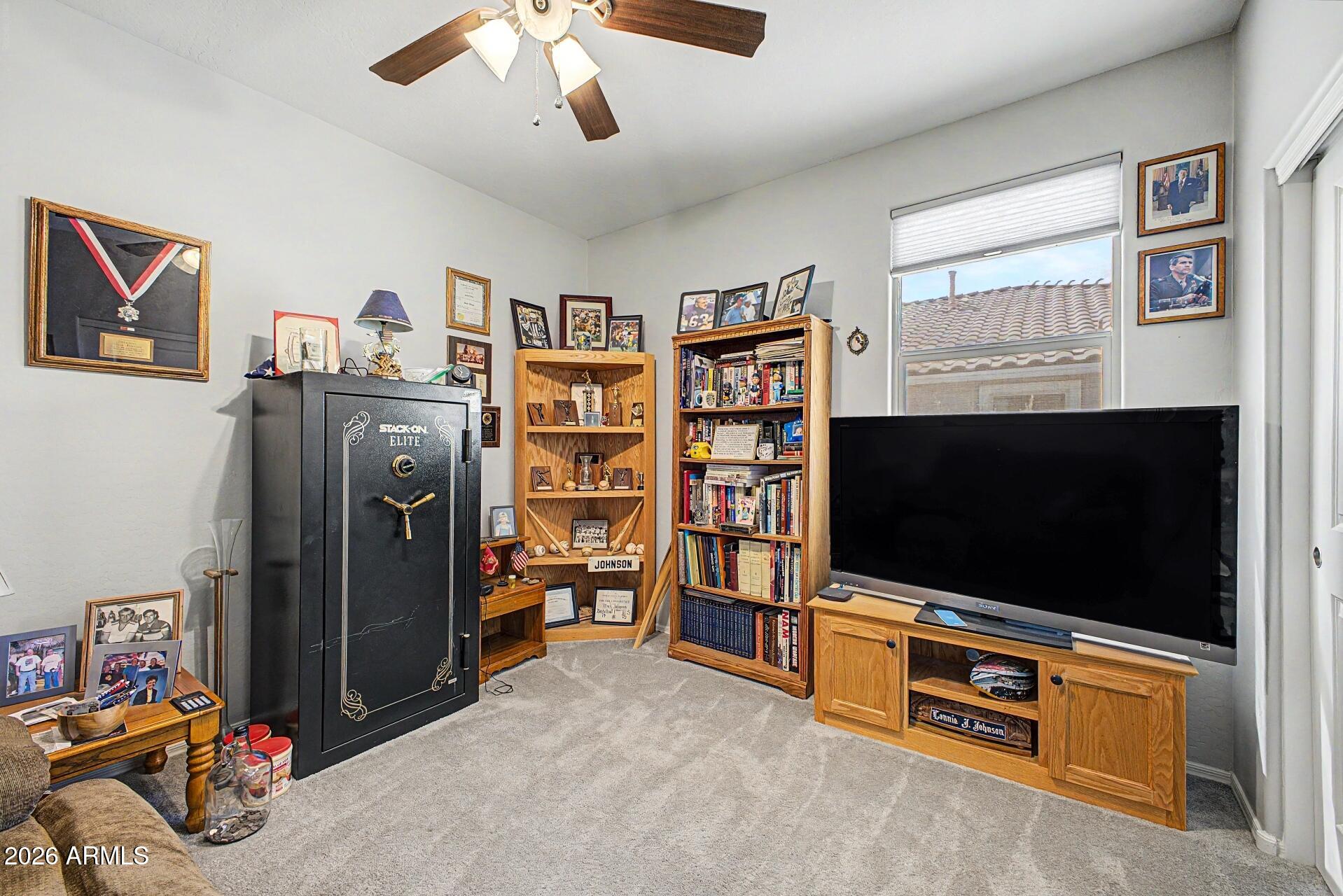 18021 West Indigo Brush Road Goodyear, AZ 85338 - Photo 23 of 47 a living room with furniture and a flat screen tv
