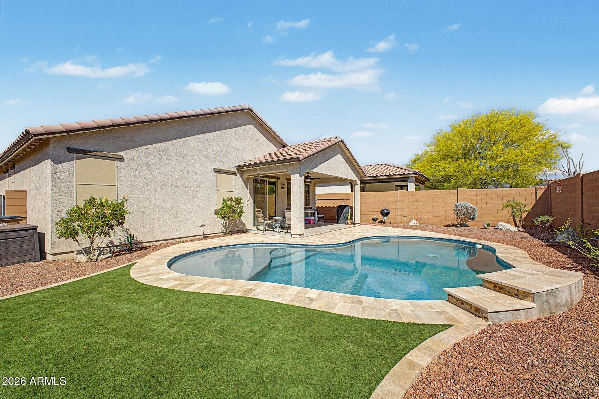 18021 West Indigo Brush Road Goodyear, AZ 85338 - Photo 27 of 47 a view of a house with pool fire pit and chairs in the patio