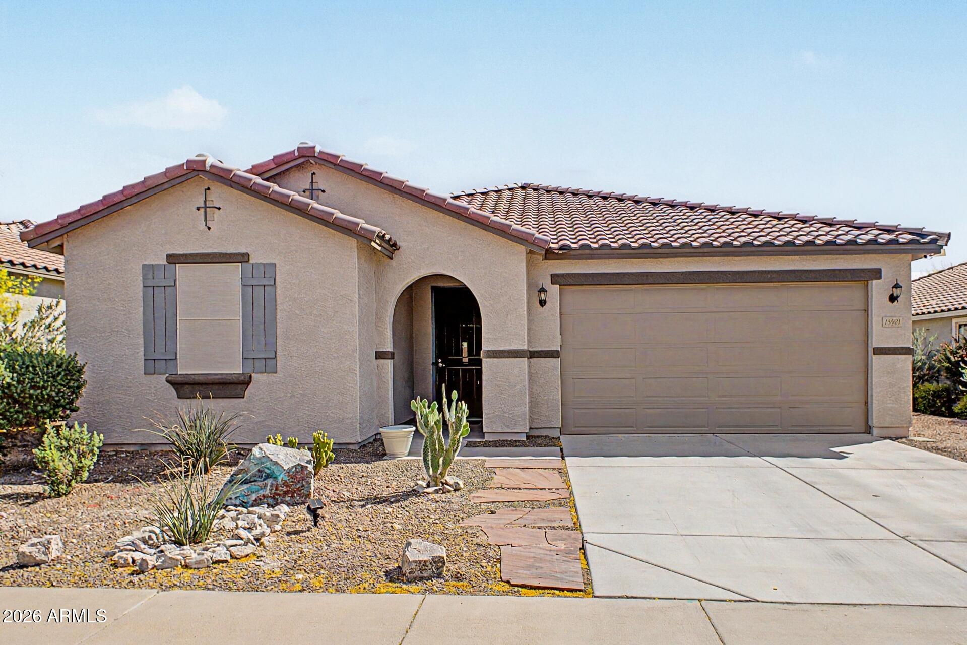 18021 West Indigo Brush Road Goodyear, AZ 85338 - Photo 3 of 47 a front view of a house