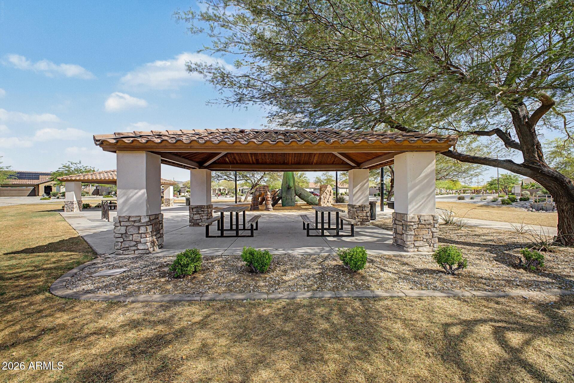 18021 West Indigo Brush Road Goodyear, AZ 85338 - Photo 33 of 47 an outdoor view of a patio with swimming pool
