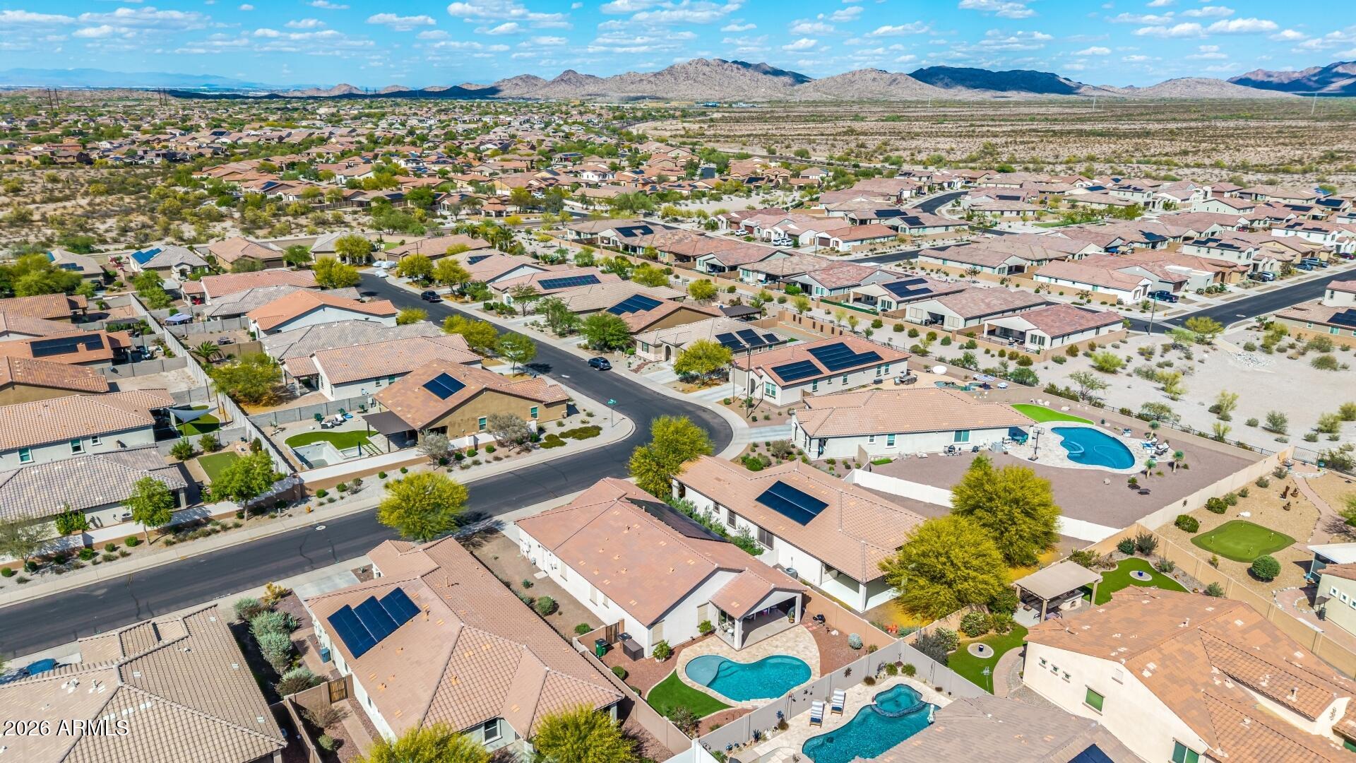18021 West Indigo Brush Road Goodyear, AZ 85338 - Photo 42 of 47 an aerial view of residential building and lake