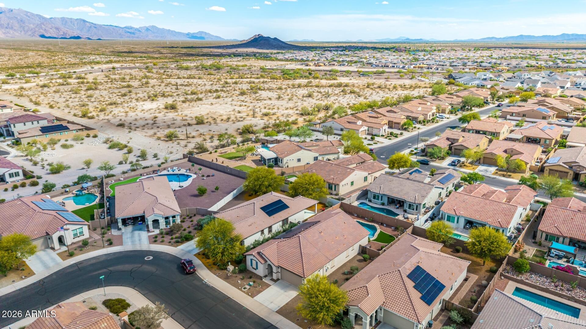 18021 West Indigo Brush Road Goodyear, AZ 85338 - Photo 43 of 47 an aerial view of residential building and lake