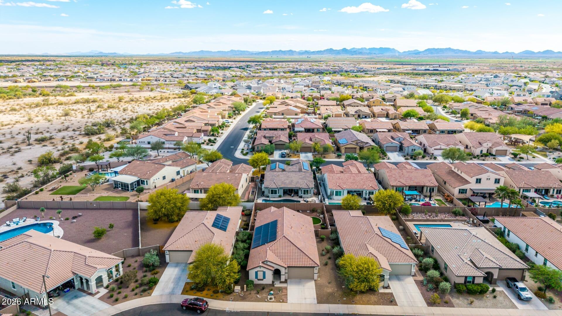18021 West Indigo Brush Road Goodyear, AZ 85338 - Photo 44 of 47 an aerial view of residential building and lake