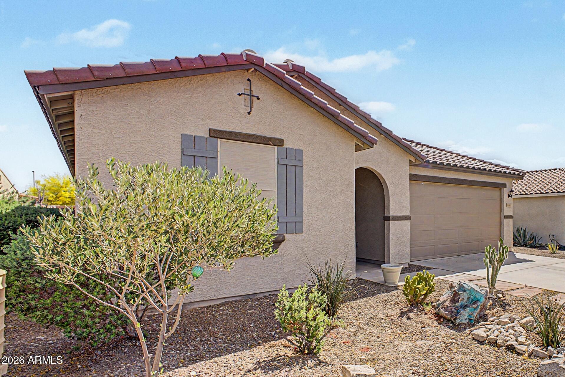 18021 West Indigo Brush Road Goodyear, AZ 85338 - Photo 47 of 47 a front view of a house with garden