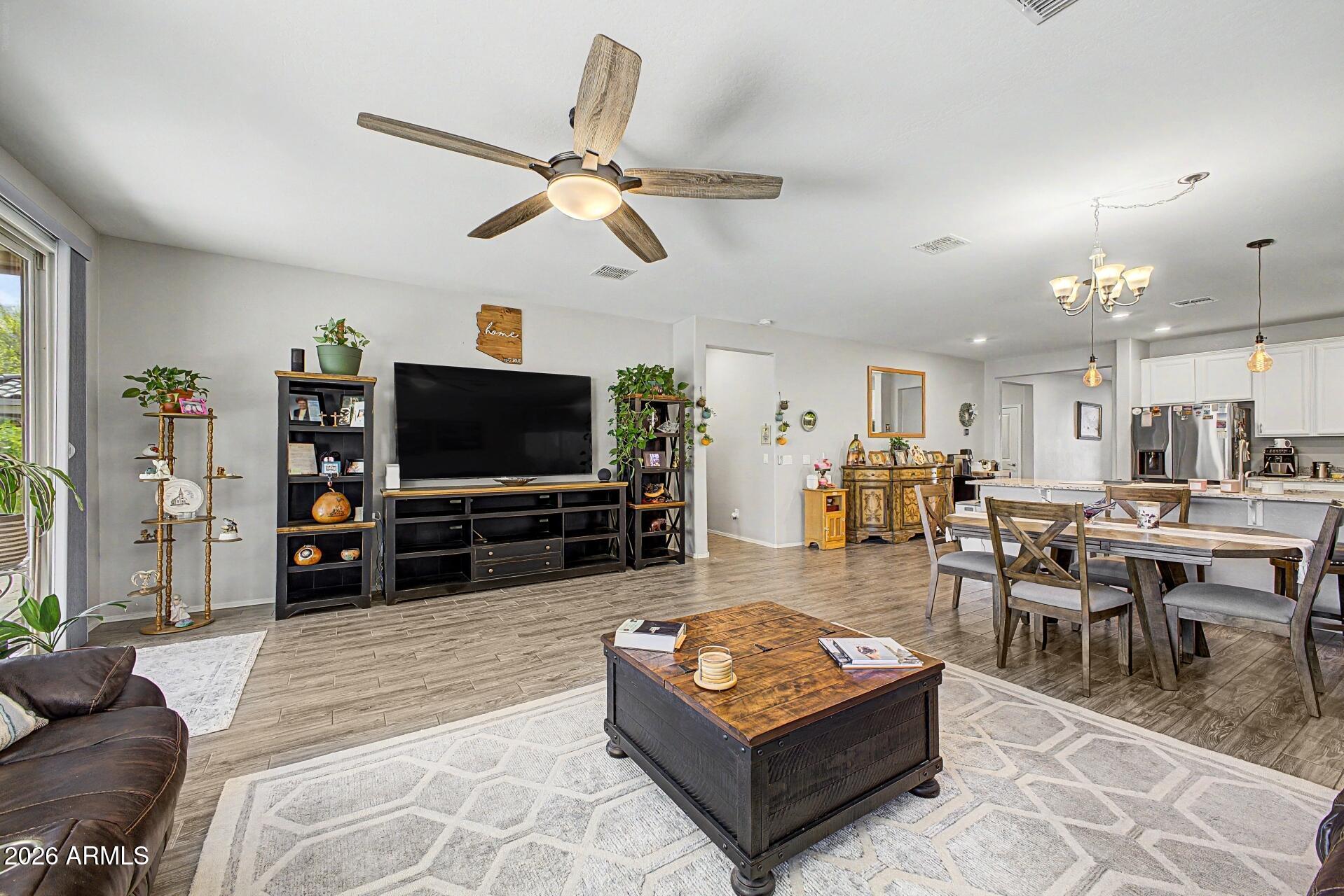 18021 West Indigo Brush Road Goodyear, AZ 85338 - Photo 5 of 47 a living room with furniture and a flat screen tv