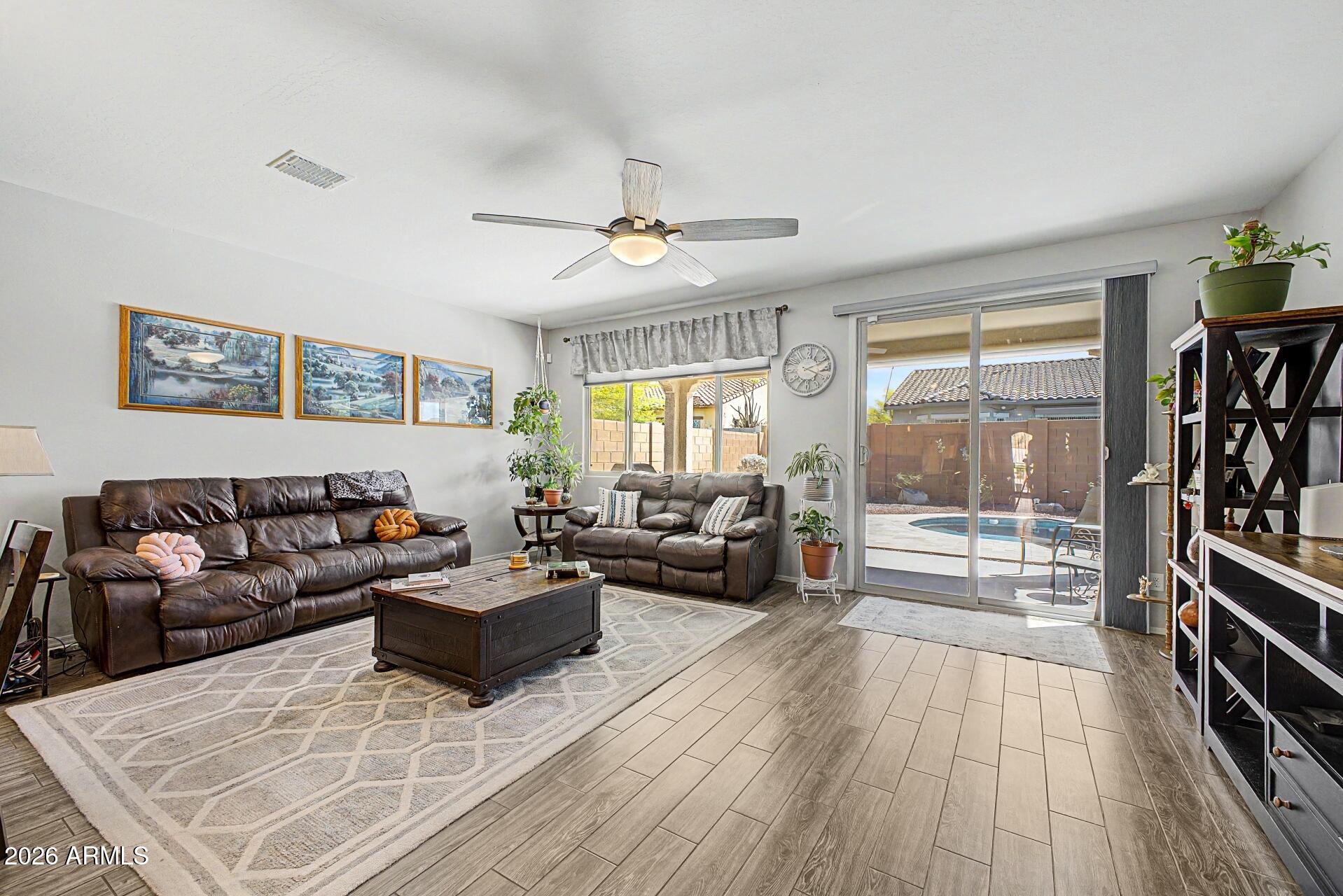 18021 West Indigo Brush Road Goodyear, AZ 85338 - Photo 6 of 47 a living room with furniture and a large window