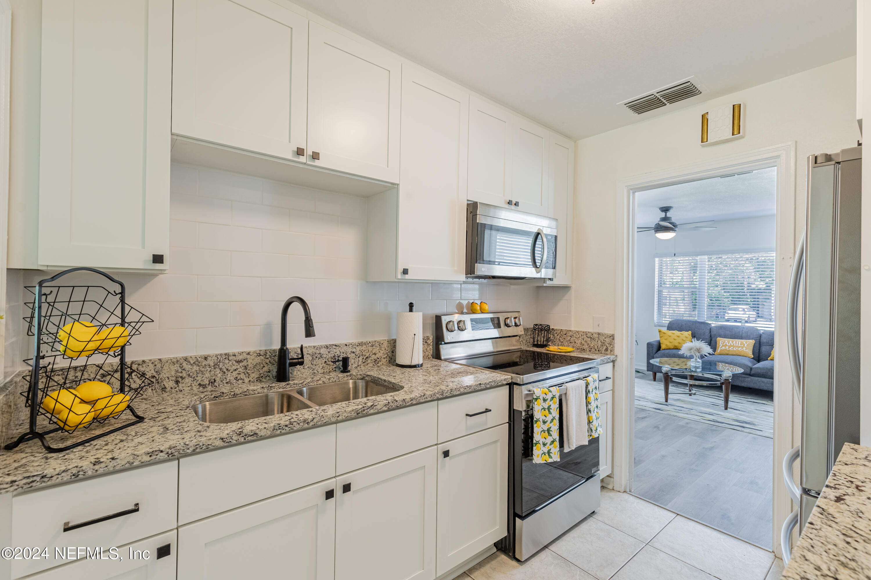 5342 Sharon Terrace Jacksonville, FL 32207 - Photo 12 of 33 a kitchen with stainless steel appliances granite countertop a sink stove and cabinets
