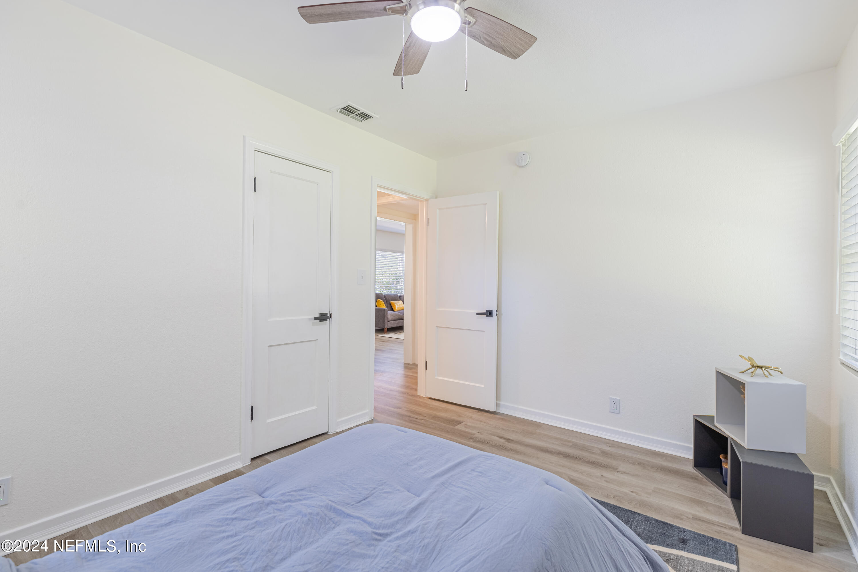 5342 Sharon Terrace Jacksonville, FL 32207 - Photo 19 of 33 a bedroom with a bed and a chandelier