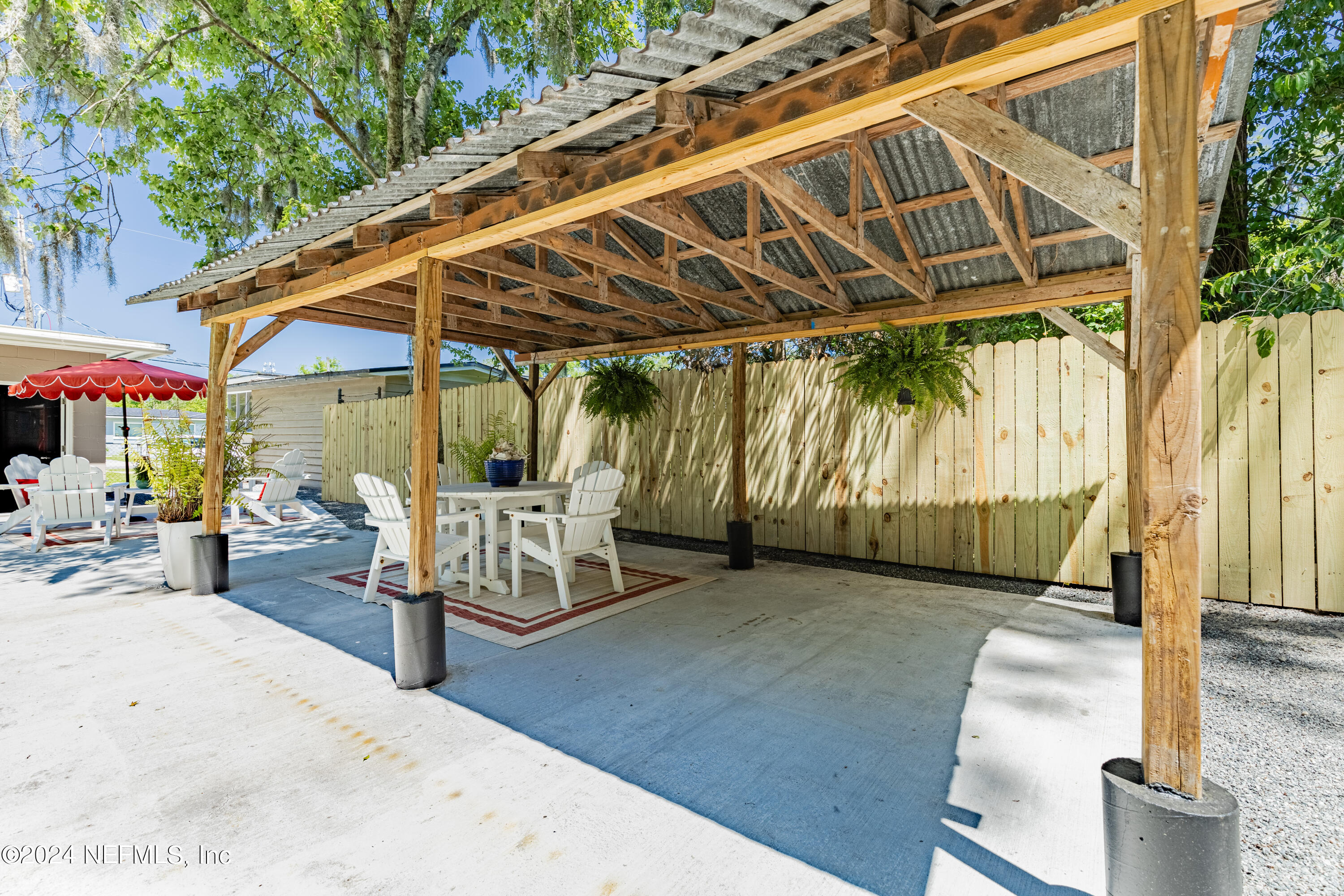 5342 Sharon Terrace Jacksonville, FL 32207 - Photo 29 of 33 a view of a patio with a table and chairs under an umbrella