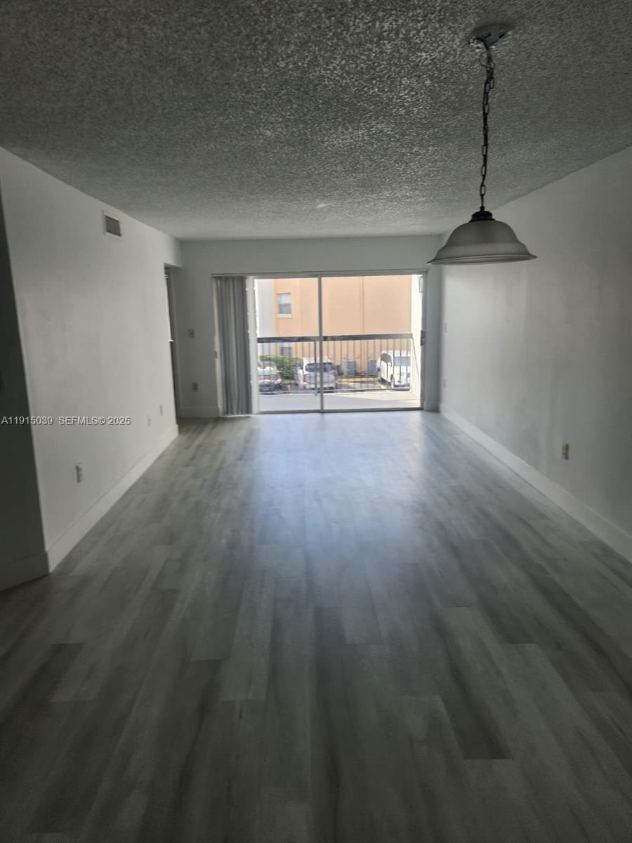 6272 Northwest 186th Street, Unit 201 Hialeah, FL 33015 - Photo 13 of 13 a view of an empty room with a window
