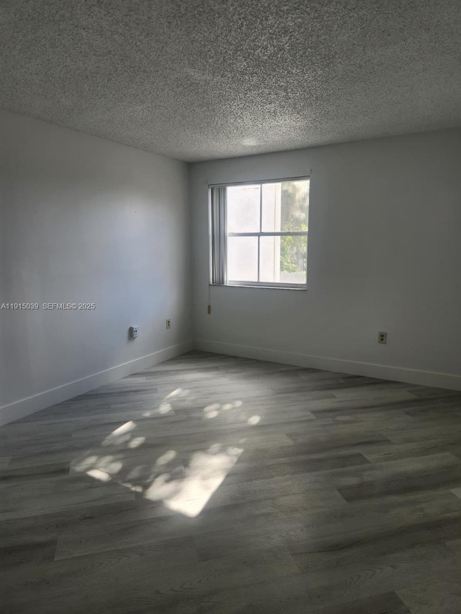 6272 Northwest 186th Street, Unit 201 Hialeah, FL 33015 - Photo 7 of 13 a view of an empty room with a window
