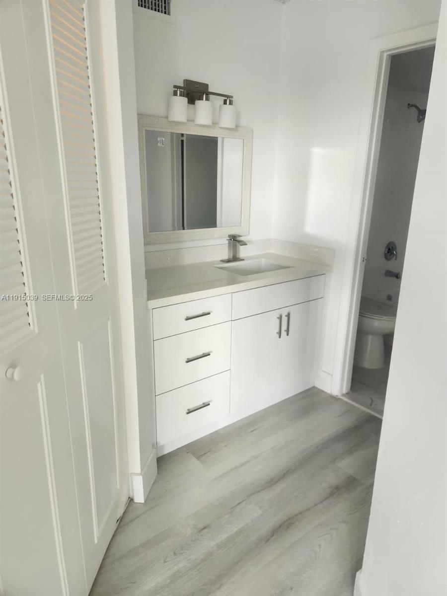 6272 Northwest 186th Street, Unit 201 Hialeah, FL 33015 - Photo 8 of 13 a bathroom with a sink and a mirror