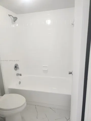 a bathroom with a toilet and a bathtub