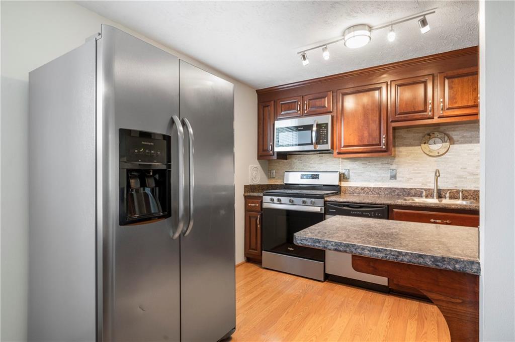 146 Pinehurst Drive Freedom, PA 15042 - Photo 11 of 30 a kitchen with stainless steel appliances granite countertop a refrigerator and a stove top oven