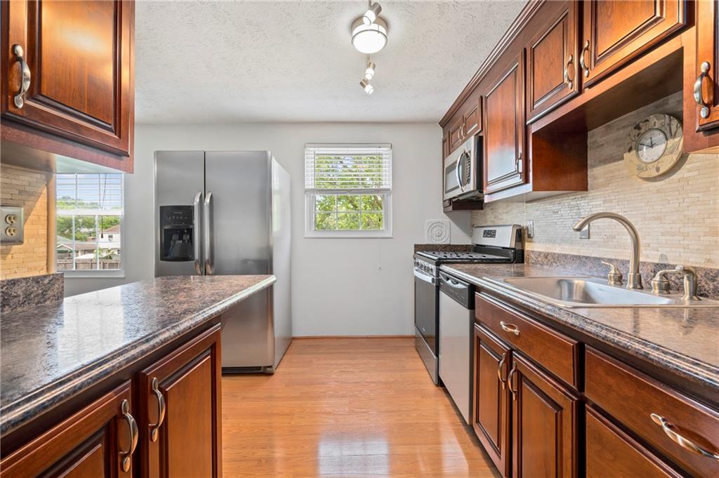 146 Pinehurst Drive Freedom, PA 15042 - Photo 14 of 30 a kitchen with stainless steel appliances granite countertop a sink stove and cabinets