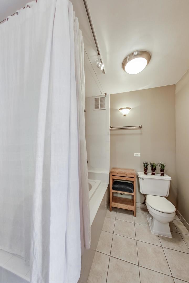 655 West Irving Park Road, Unit 3302 Chicago, IL 60613 - Photo 18 of 37 a bathroom with a sink a toilet and a shower