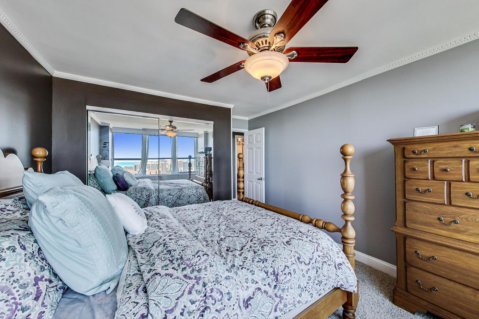 655 West Irving Park Road, Unit 3302 Chicago, IL 60613 - Photo 21 of 37 a bedroom with a large bed and dresser