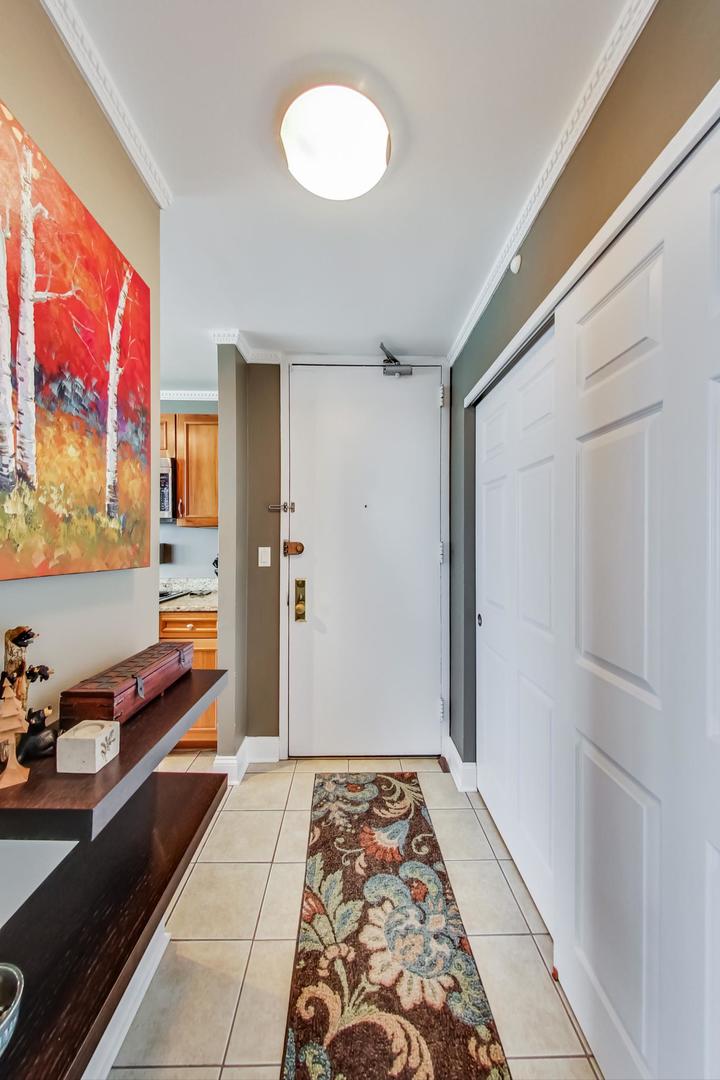655 West Irving Park Road, Unit 3302 Chicago, IL 60613 - Photo 24 of 37 a view of a hallway with wooden floor and furniture