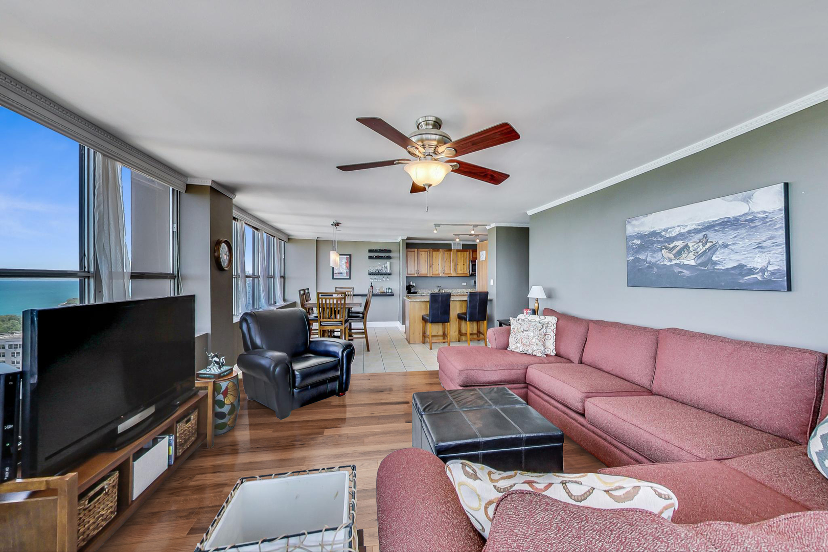 655 West Irving Park Road, Unit 3302 Chicago, IL 60613 - Photo 3 of 37 a living room with furniture and a flat screen tv