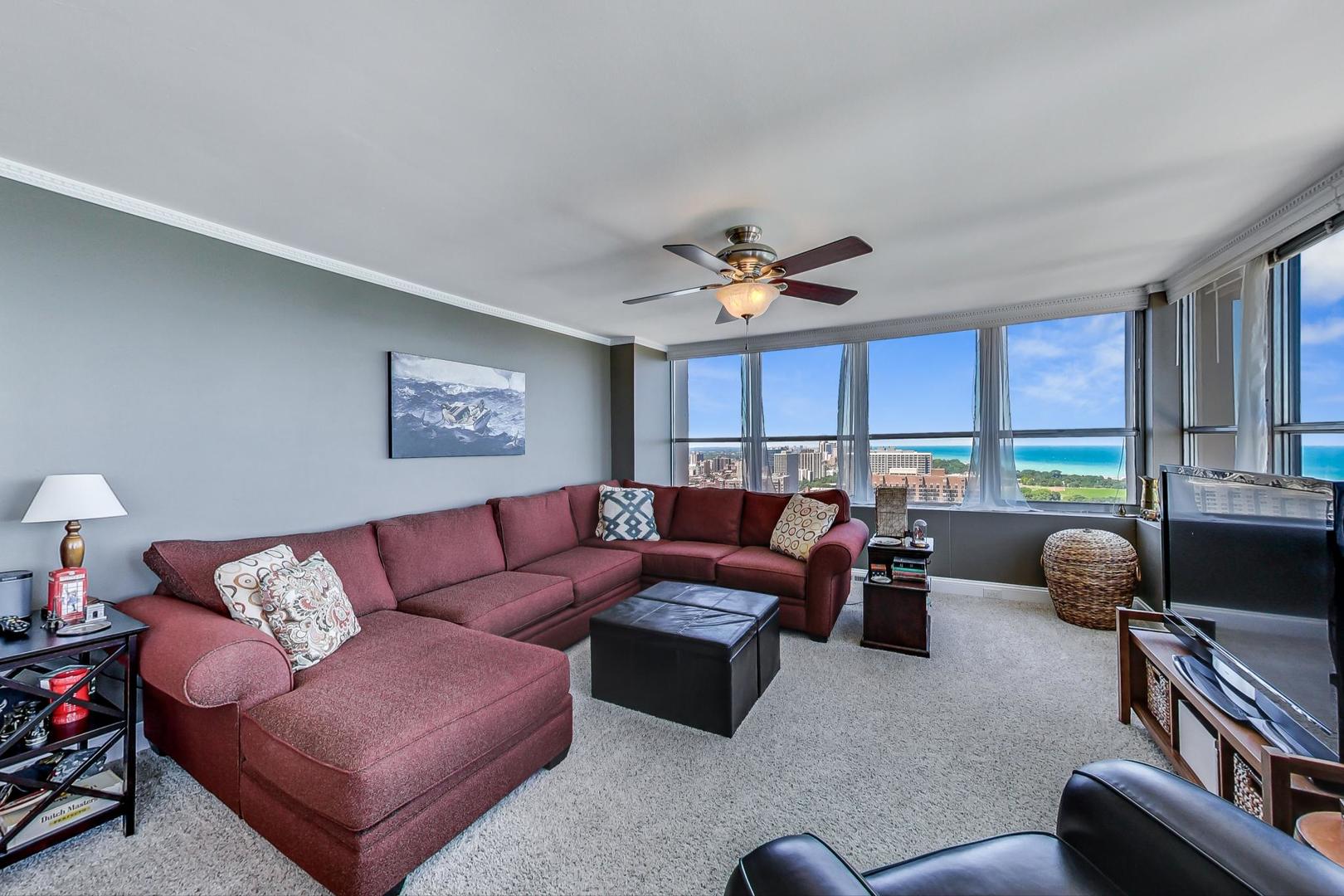 655 West Irving Park Road, Unit 3302 Chicago, IL 60613 - Photo 5 of 37 a living room with furniture a fireplace and a window