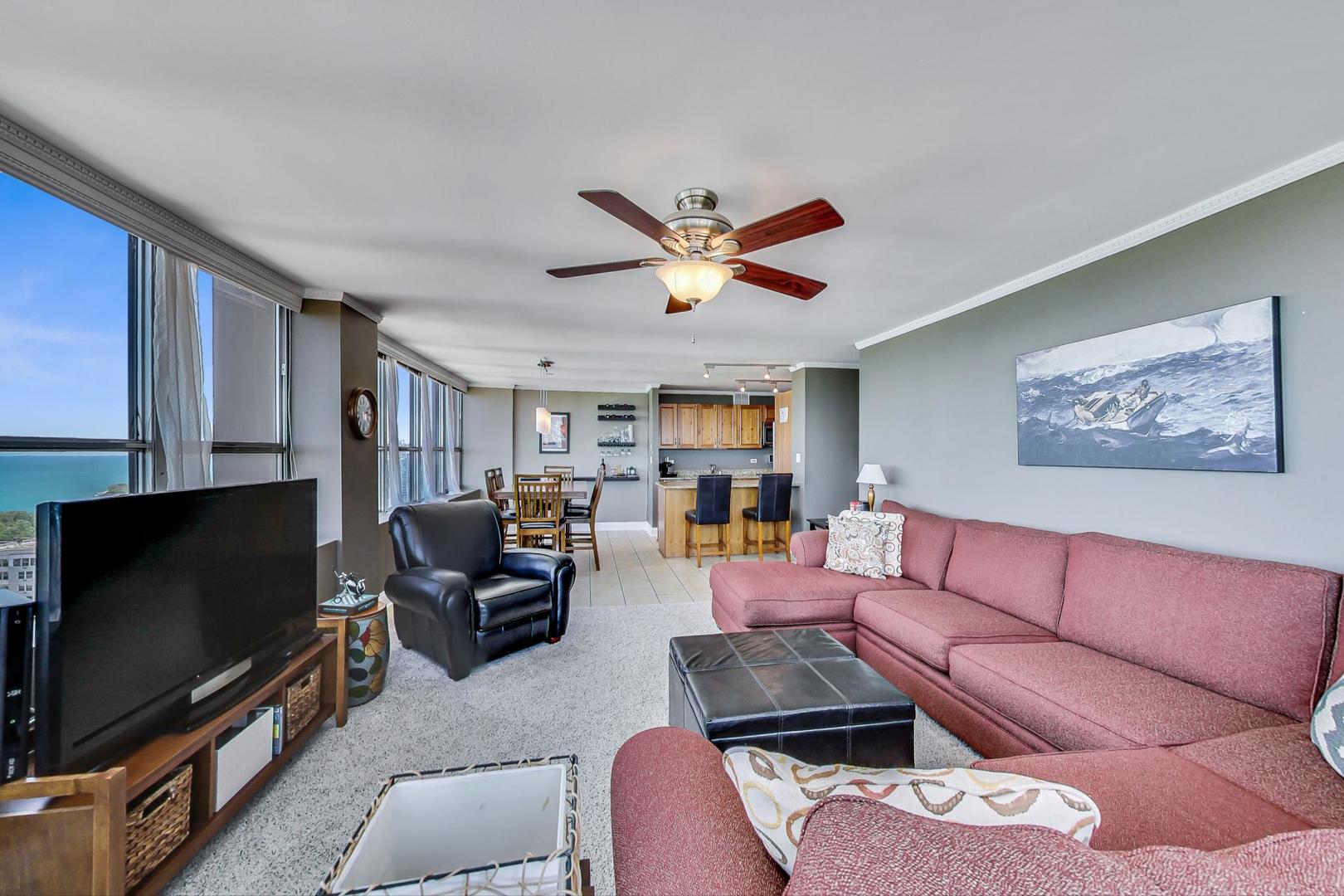 655 West Irving Park Road, Unit 3302 Chicago, IL 60613 - Photo 6 of 37 a living room with furniture and a flat screen tv