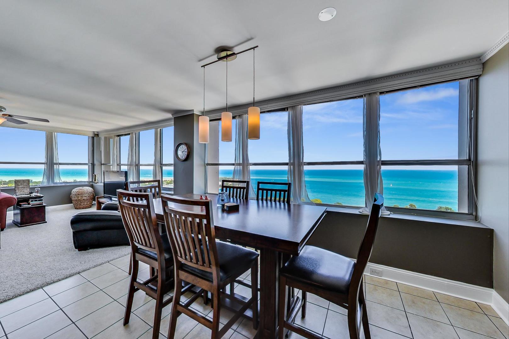 655 West Irving Park Road, Unit 3302 Chicago, IL 60613 - Photo 7 of 37 a view of a dining room with furniture window and outside view