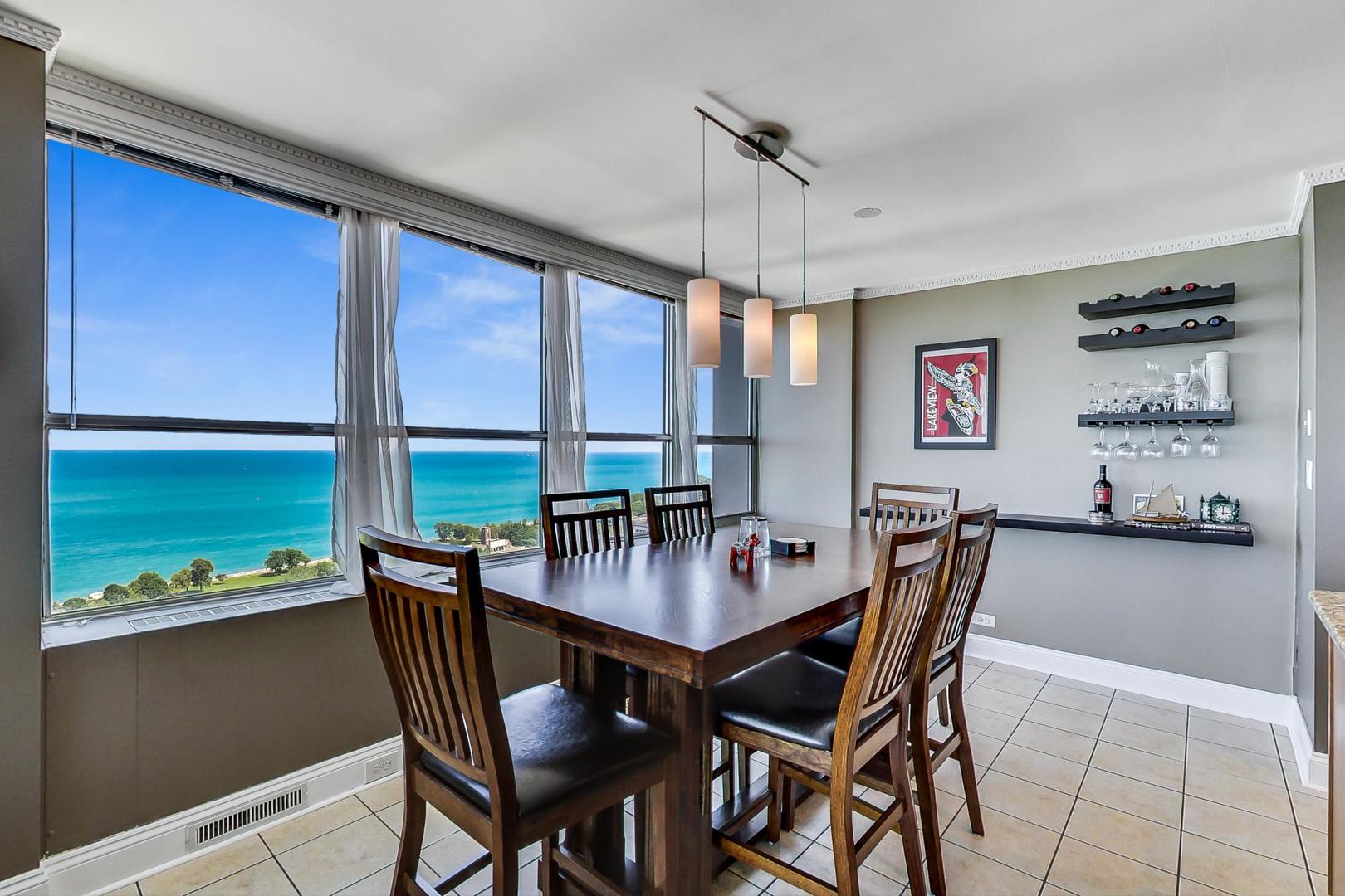 655 West Irving Park Road, Unit 3302 Chicago, IL 60613 - Photo 8 of 37 a view of a dining room with furniture window and outside view