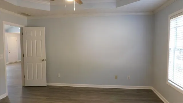 a bathroom with a white bath tub and a window