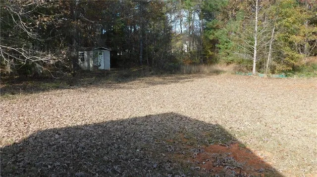 a view of a backyard with large trees