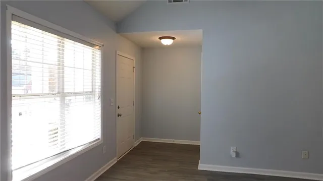 a living room with wooden floor and a fireplace