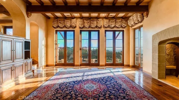 a view of a fireplace with windows and wooden floor
