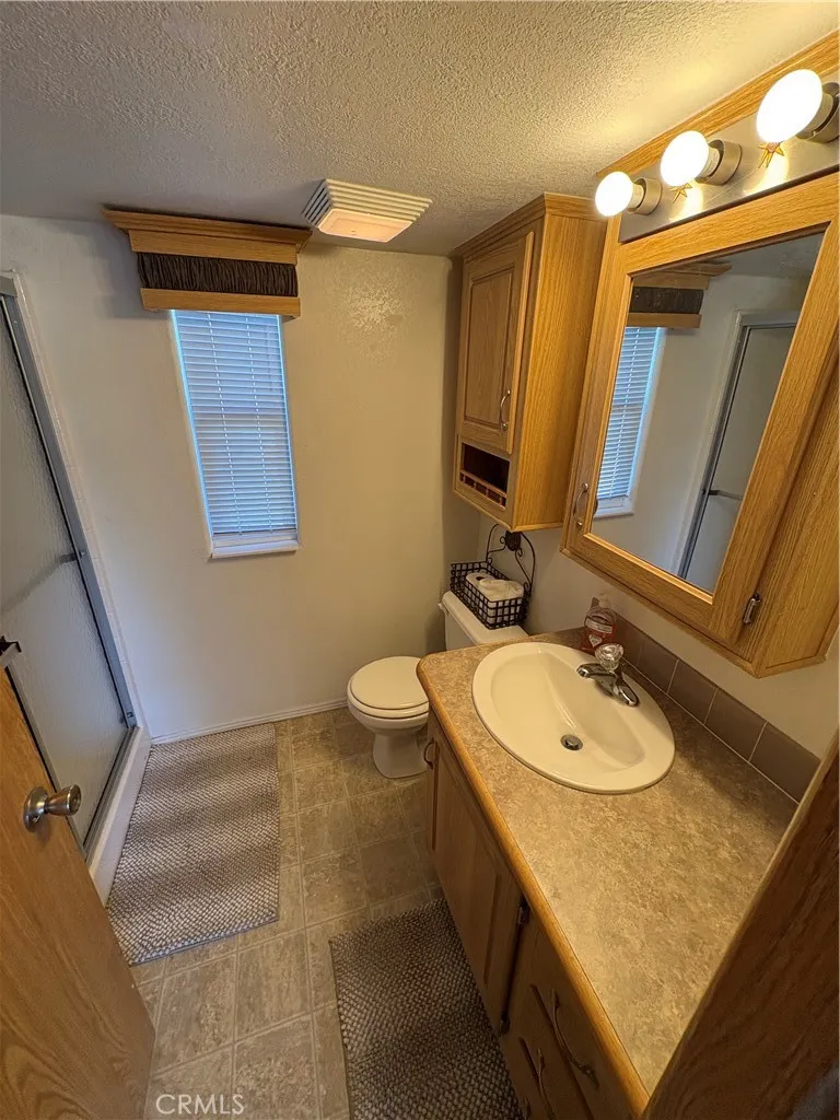 2358 Comanche Way Paso Robles, CA 93446 - Photo 20 of 30 a bathroom with a granite countertop sink and a mirror
