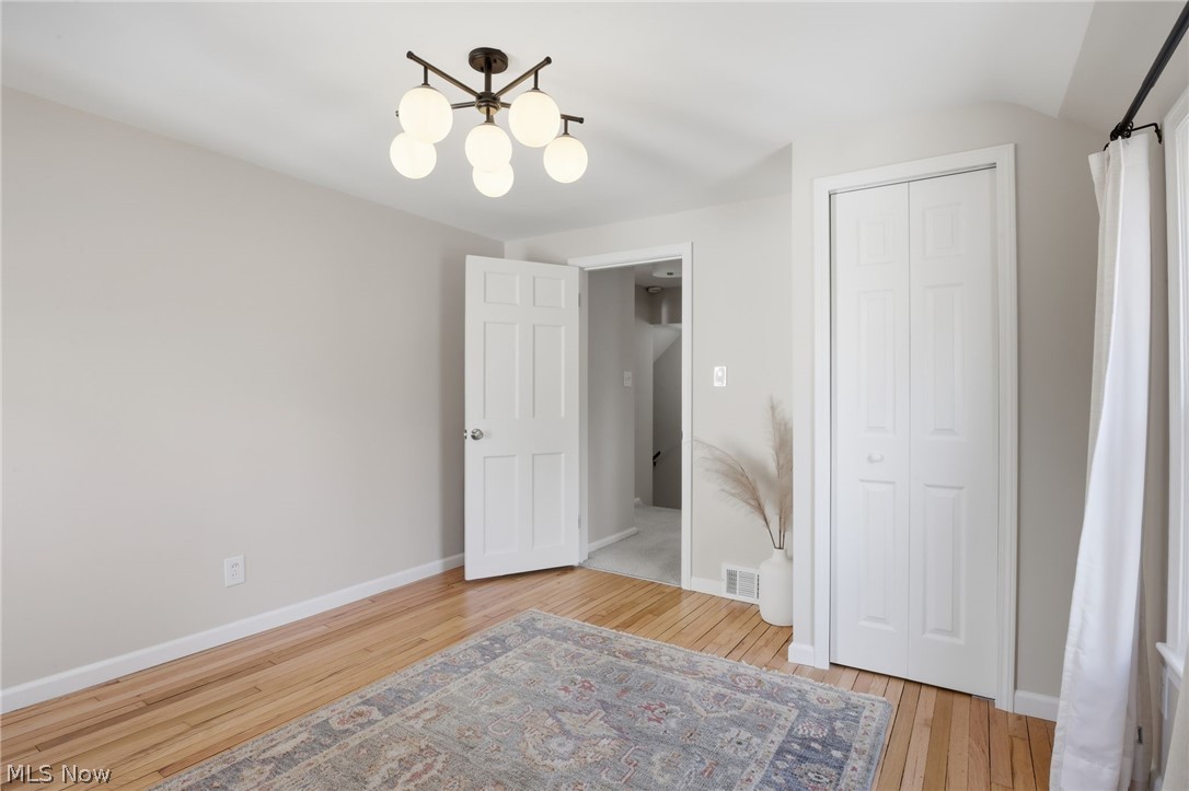 1390 Brainard Road Lyndhurst, OH 44124 - Photo 20 of 33 Unfurnished bedroom featuring light wood-type flooring, a closet, and vaulted ceiling