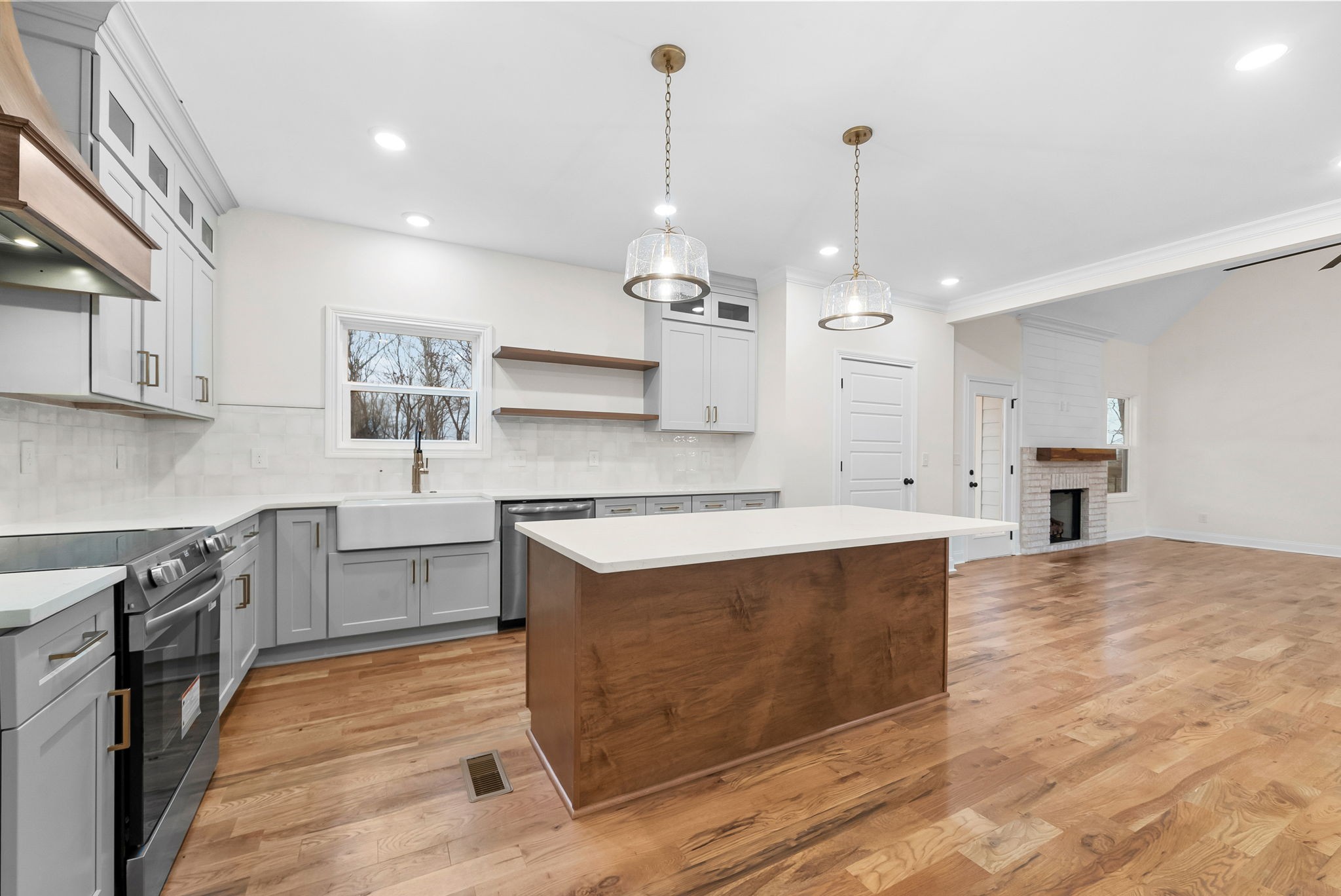1800 Gholson Road Clarksville, TN 37043 - Photo 25 of 33 a large kitchen with kitchen island a stove a sink a center island and wooden floor