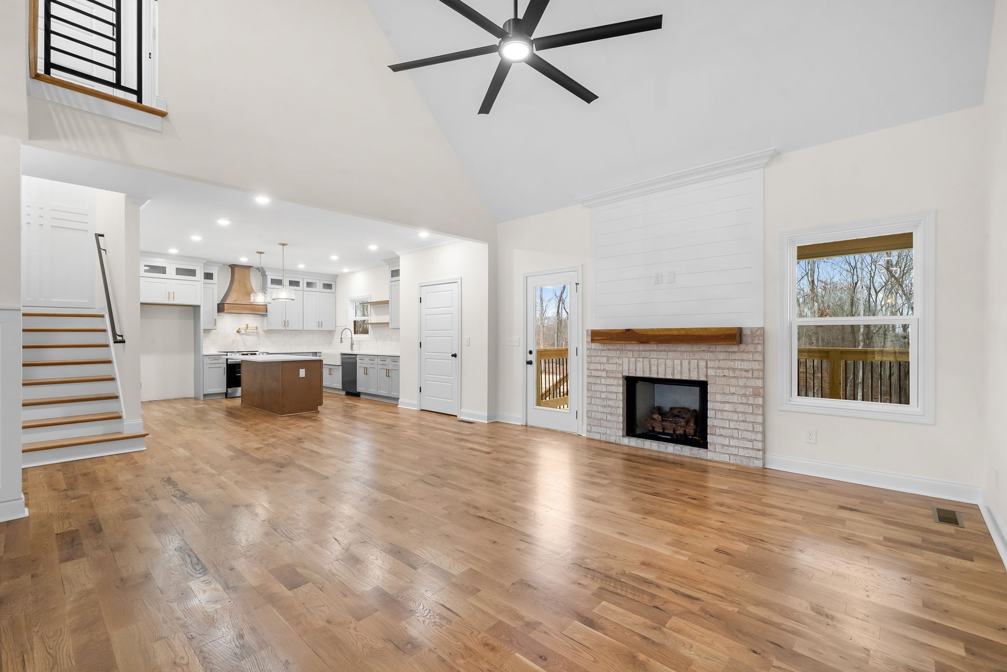 1800 Gholson Road Clarksville, TN 37043 - Photo 5 of 33 a view of a livingroom with a fireplace a ceiling fan and windows