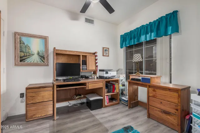 a view of a workspace with furniture and a window