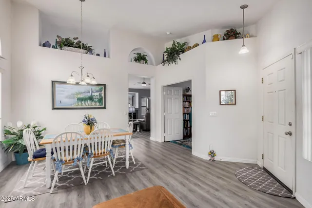 a dining room with furniture wooden floor and a chandelier