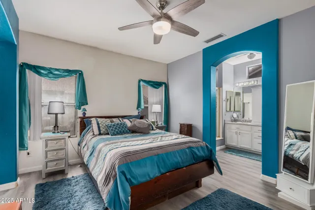 a bedroom with a bed and a chandelier