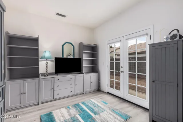 a view of an empty room with a fireplace and cabinet